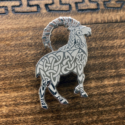 Norse god Thor, depicted as a goat enamel pin. The pin is silver plated and contains knotwork.